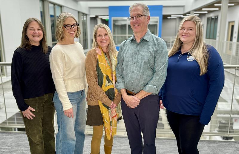 Board of Education members stand in a group