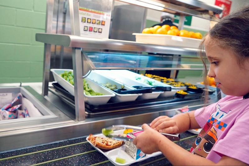 Student with food tray in school cafeteria