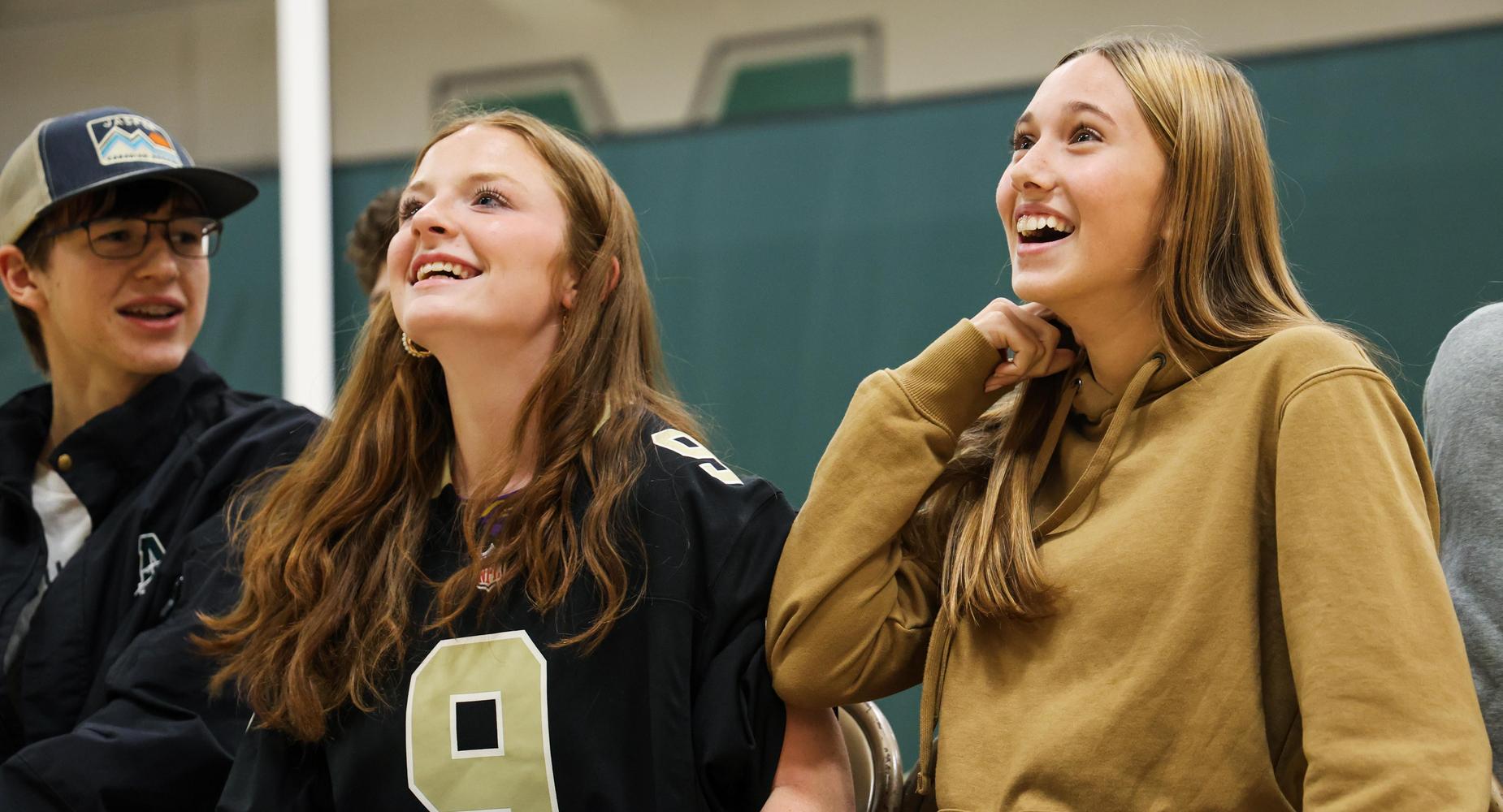 Students sit in gymnasium