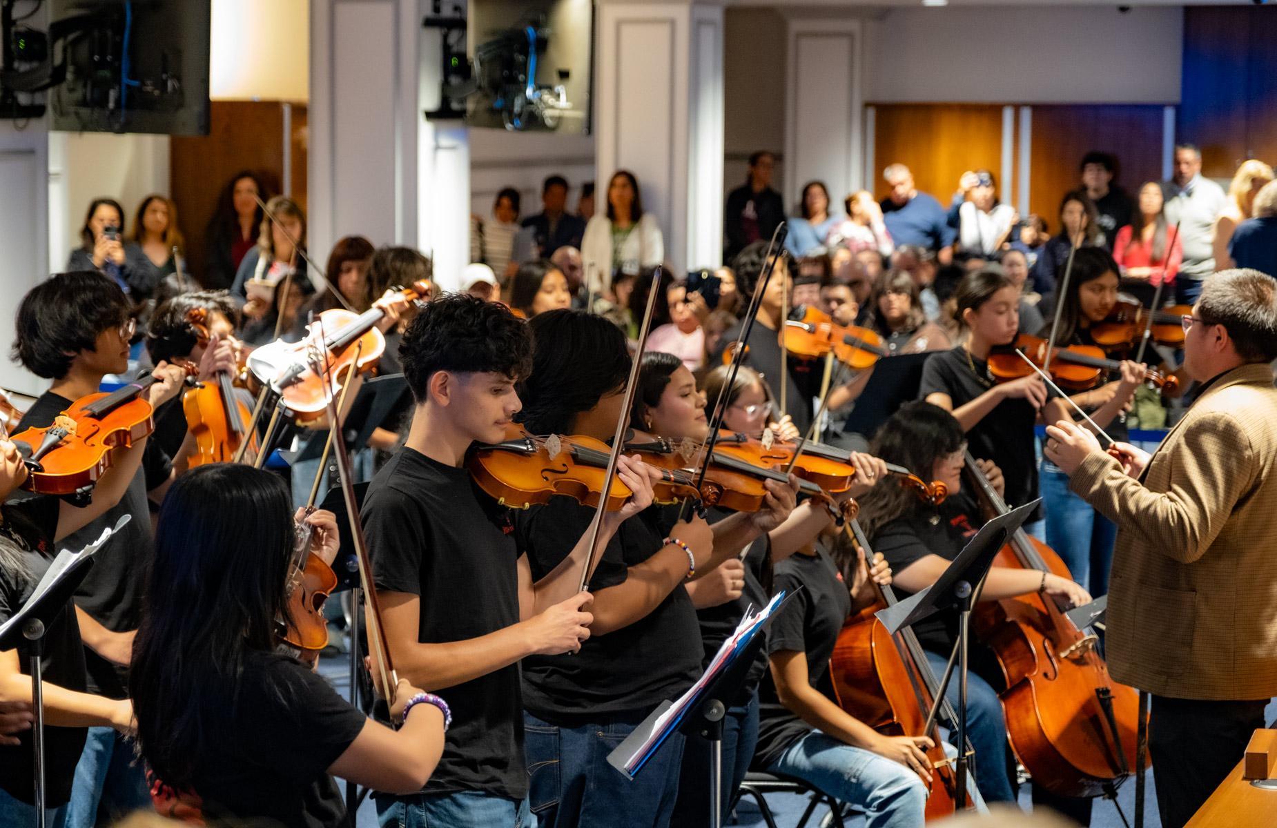 Pomona High Schoo Band performs in front of school board, and community