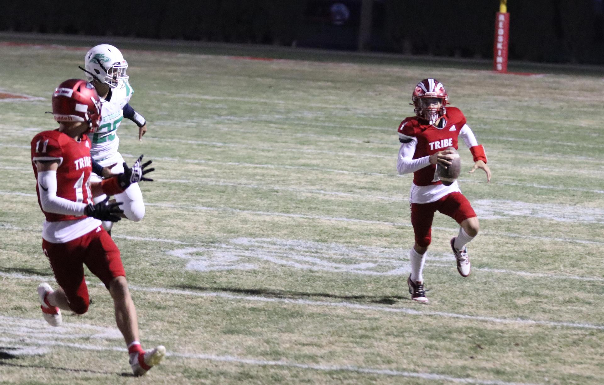varsity football players in action against Riverdale