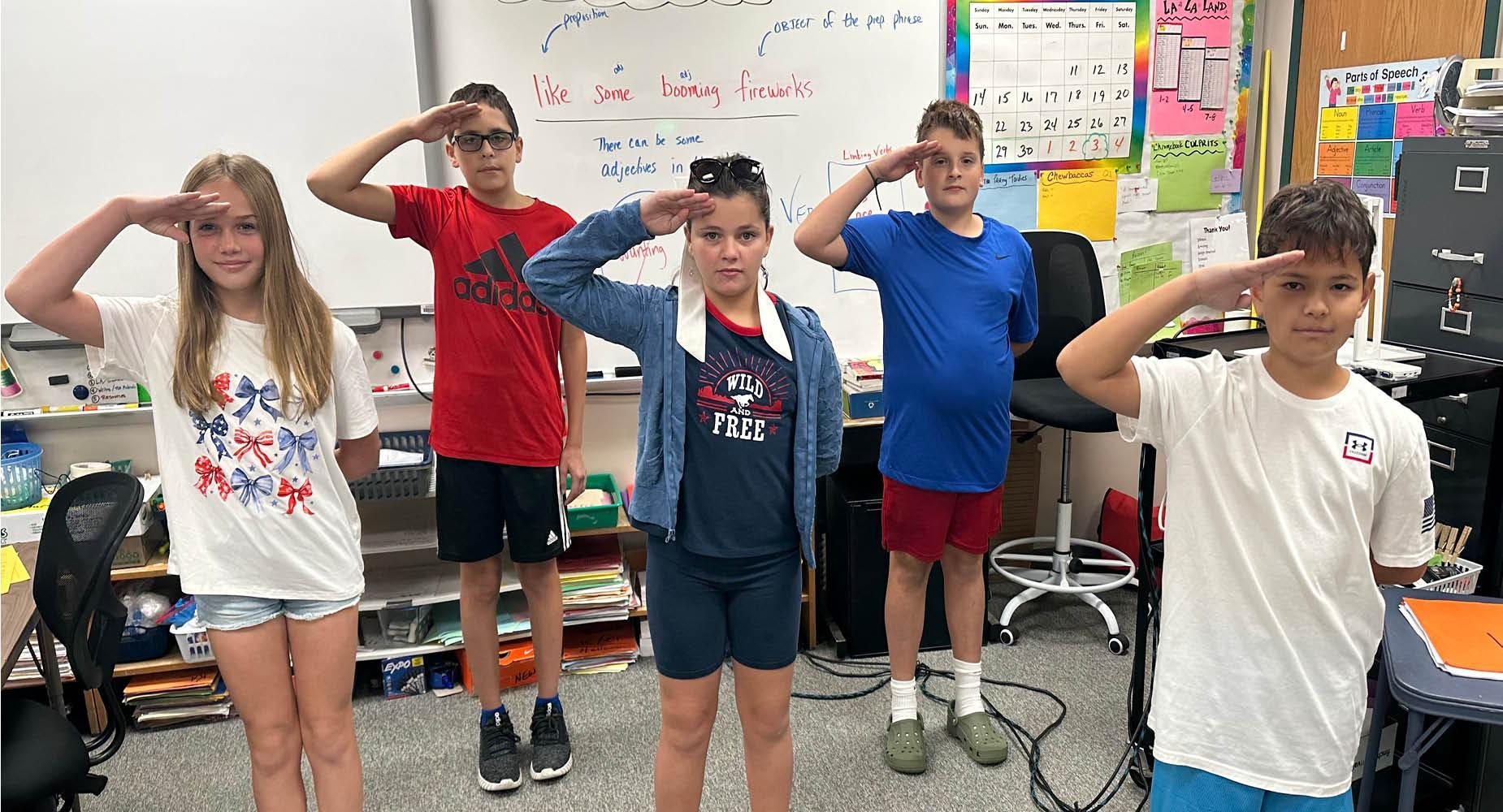 Trafford Middle School students salute on 9/11/25 in honor of the sacrifices made for our country
