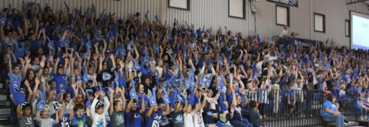 Crowd of people sitting in a gymnasium