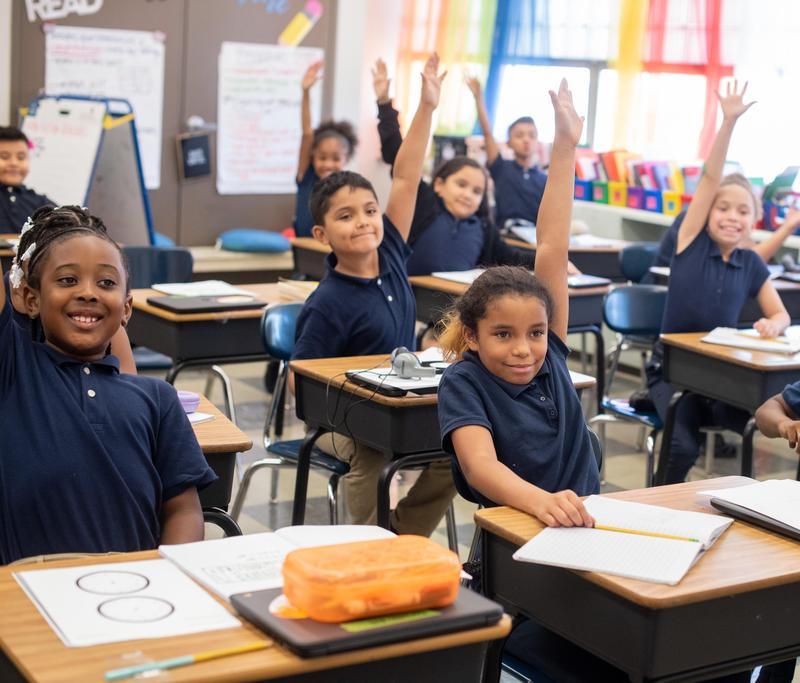 Students raise their hands in class at Renaissance Lutheran School