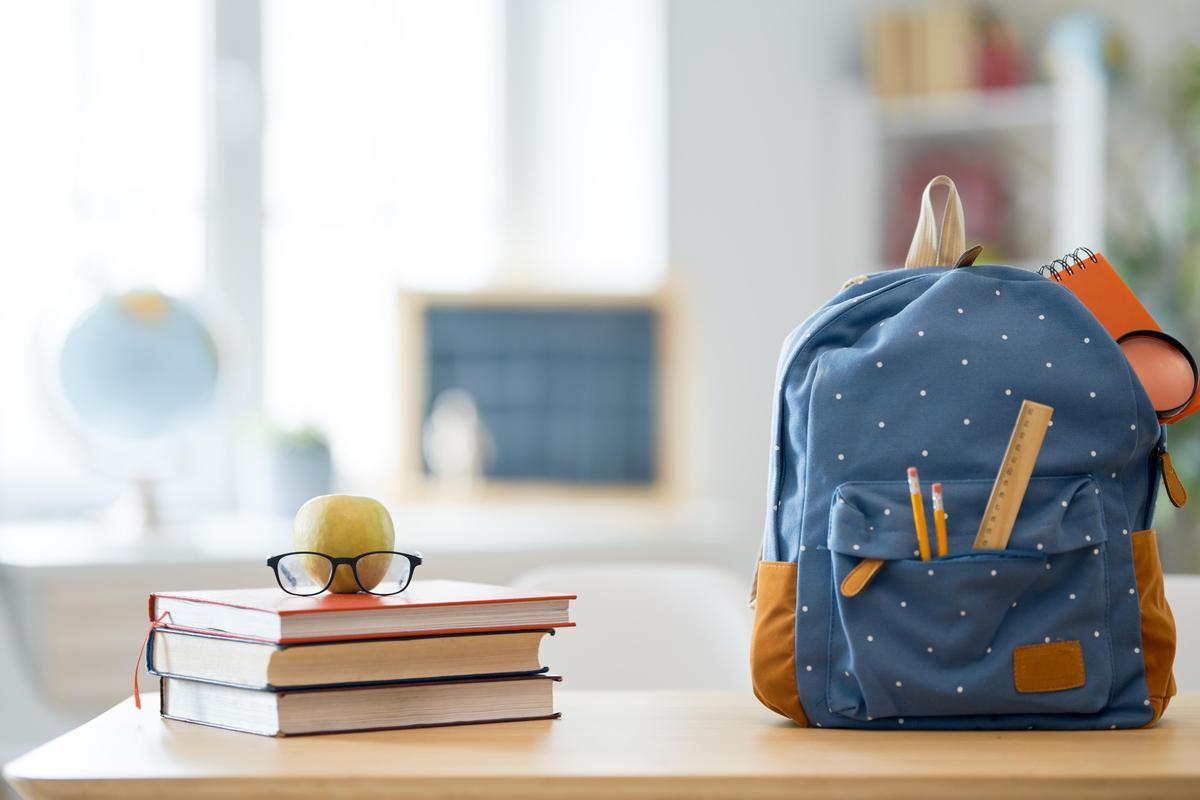 Books and a backpack sitting next to each other on a table