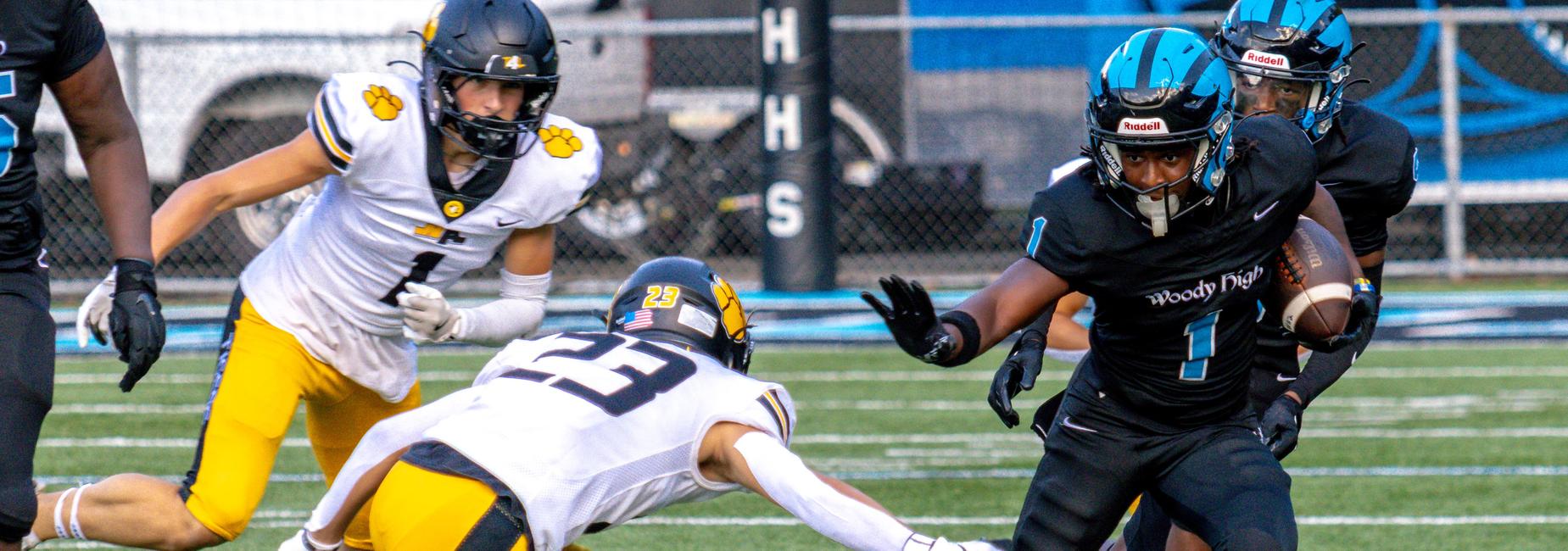 A high school football player makes a move