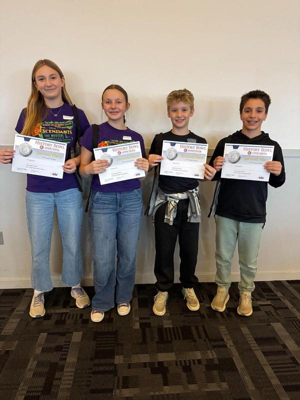 Image depicts a team of Quaker Valley students posing with their certificates after participating in the history bowl at the Heinz History Center.