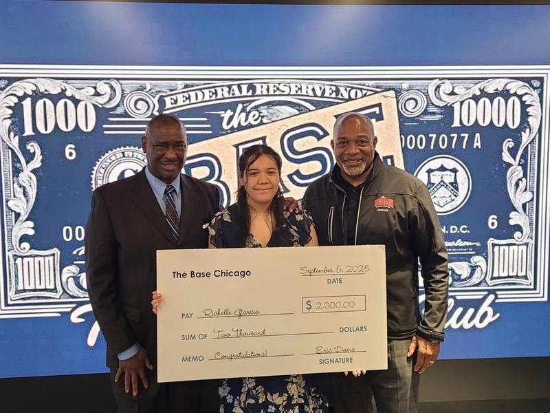 Student with giant check for success in investing