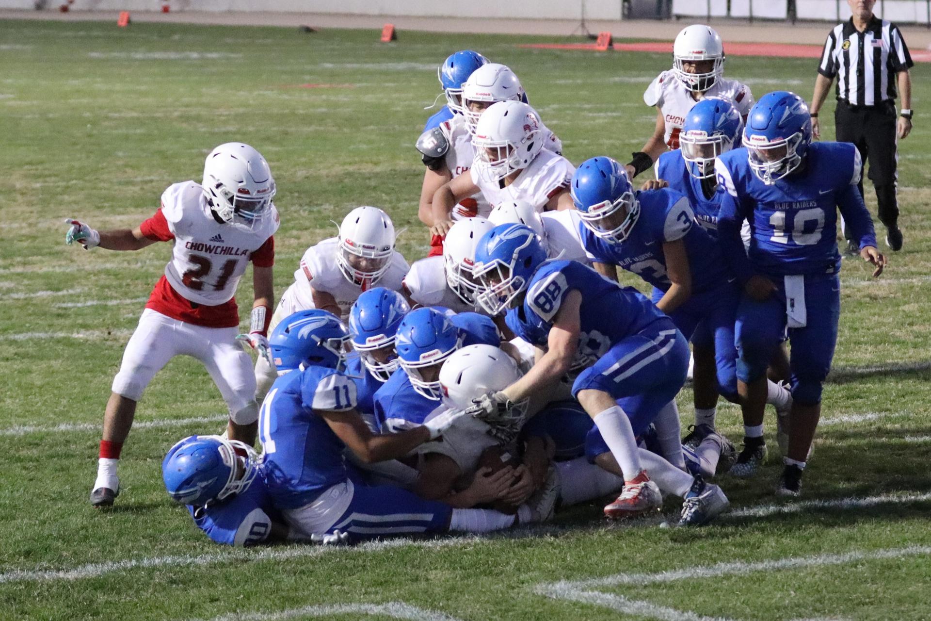 Junior Varsity football players in action against Caruthers