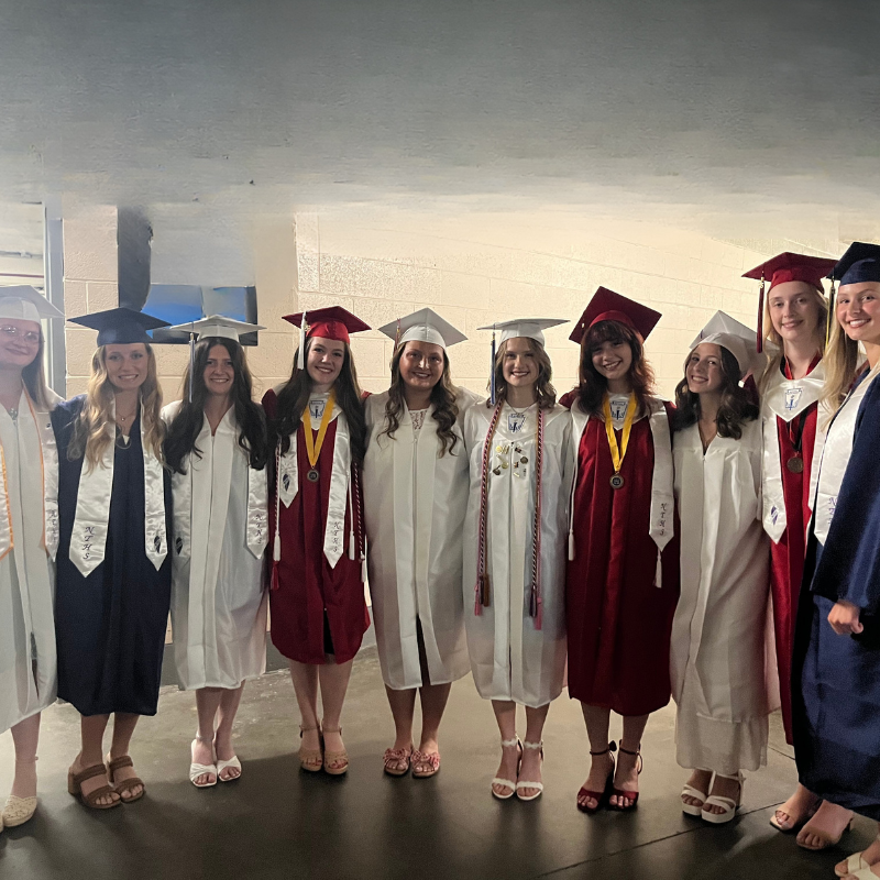 10 students in different colored caps and gowns