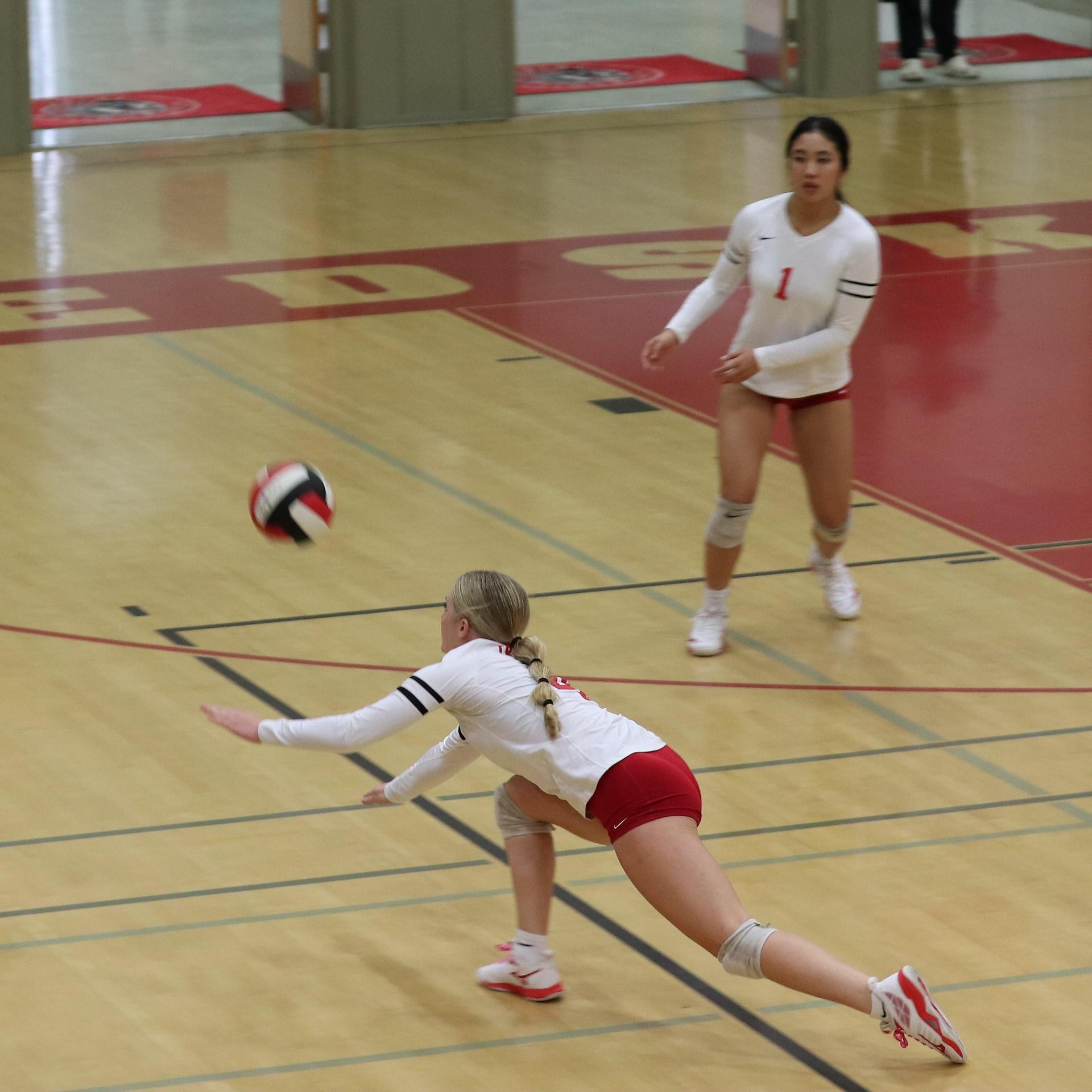 varsity volleyball players in action against Minarets