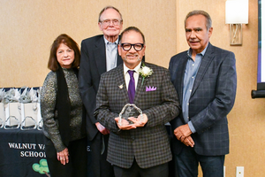 Classified Employee of the Year, John Rodriguez accepts his award from the Personnel Commission.