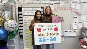 photo of courtney collins and erika lopez holding up a sign that reads Teacher of the Year