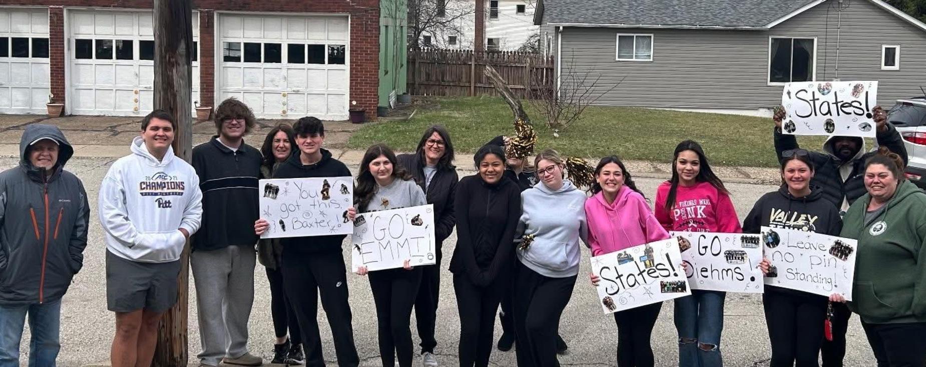 Valley students holding signs encouraging students that made it to bowling states.