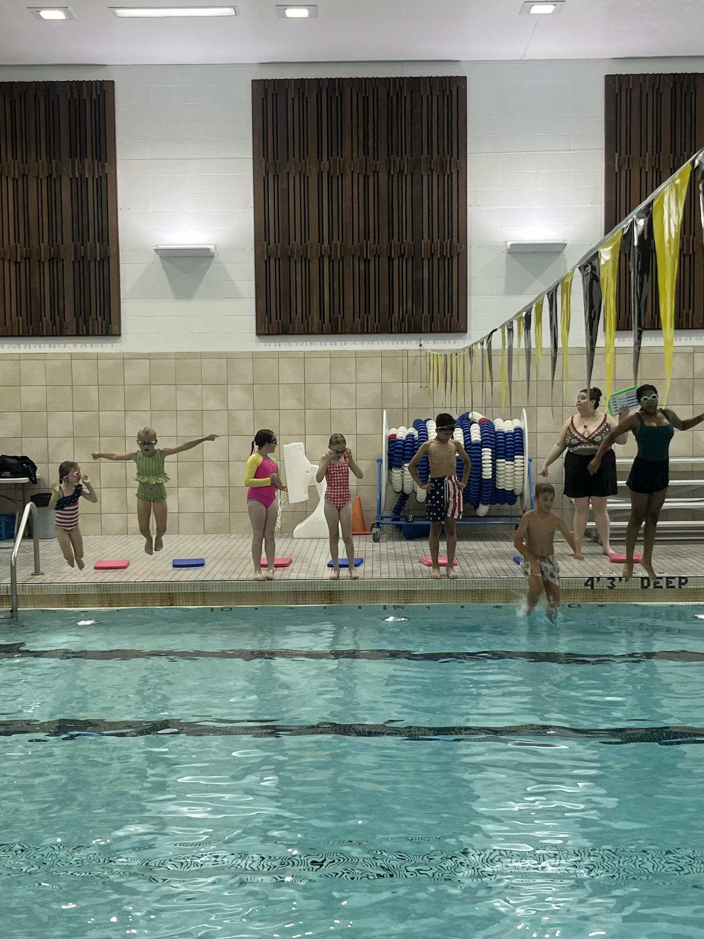 kids jumping into pool