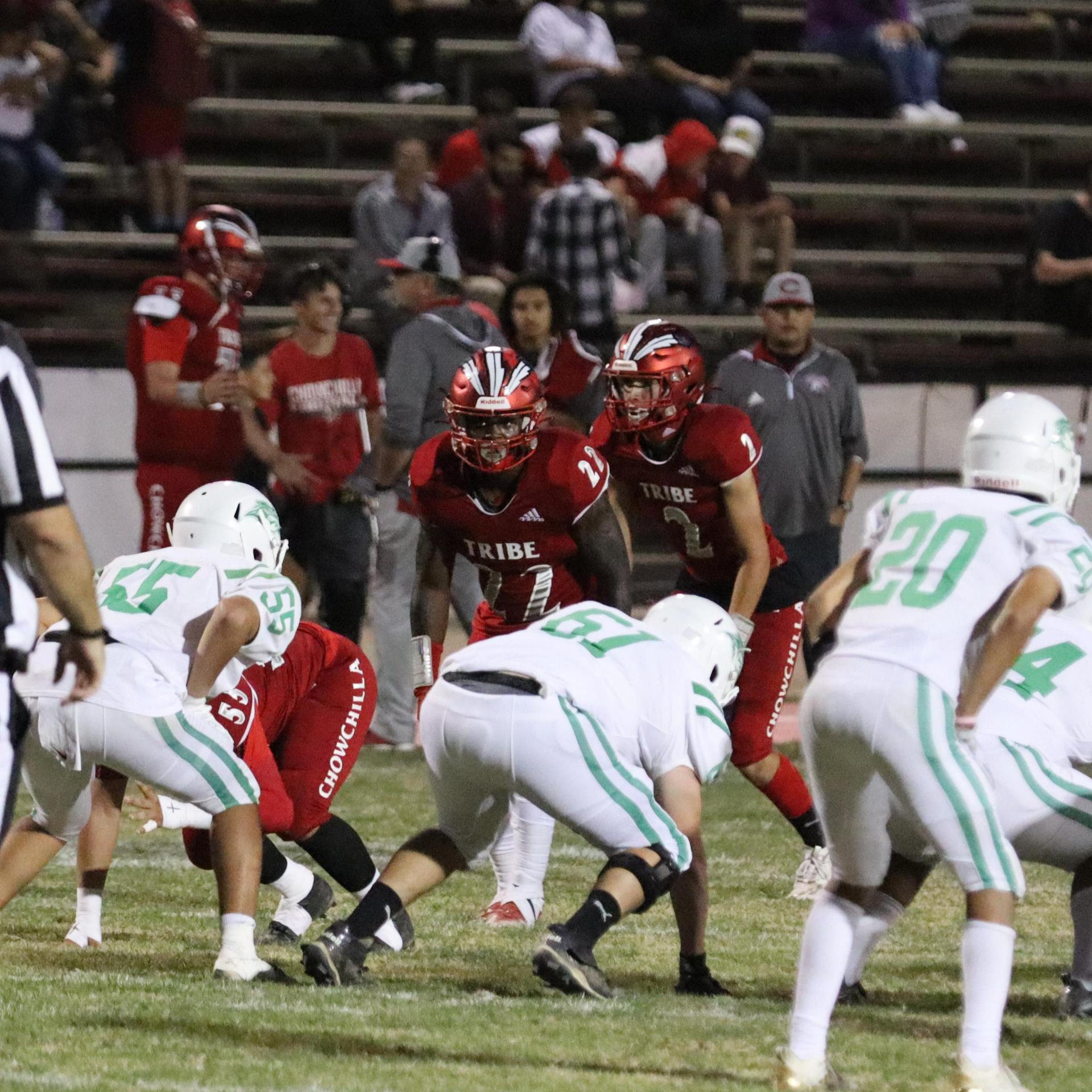 varsity football players in action against Riverdale