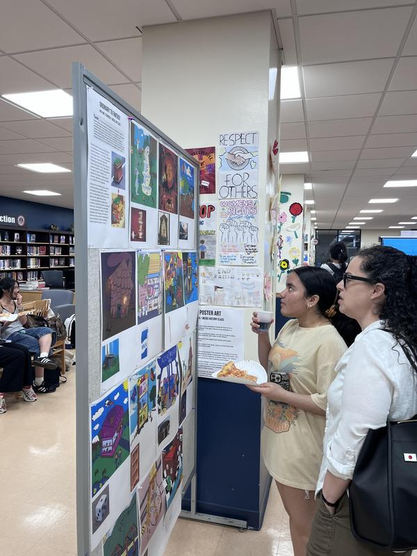 people viewing art on board