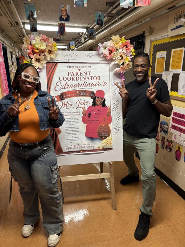 Mrs. Jakes with a sign showing appreciation