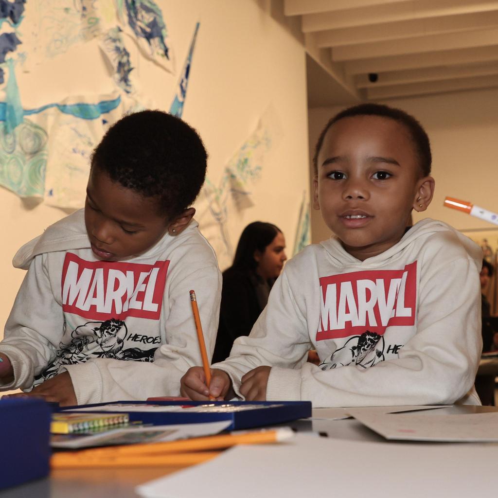 Two children working on art