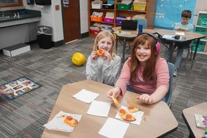 Students enjoying the pizza they made.