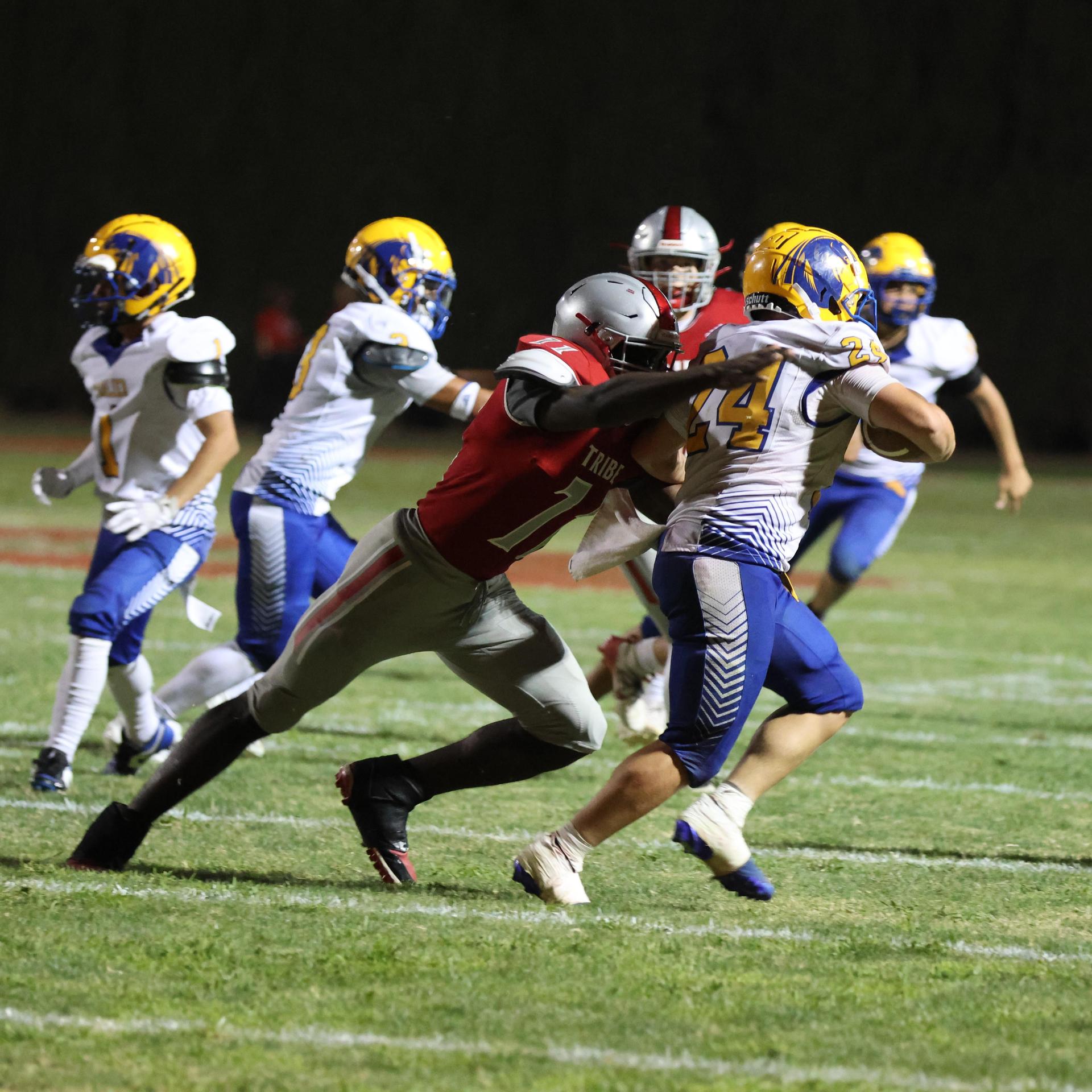 Varsity football players in action against Parlier 30