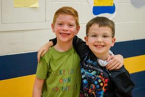 Students posing and smiling together at Legacy Family Steam Night