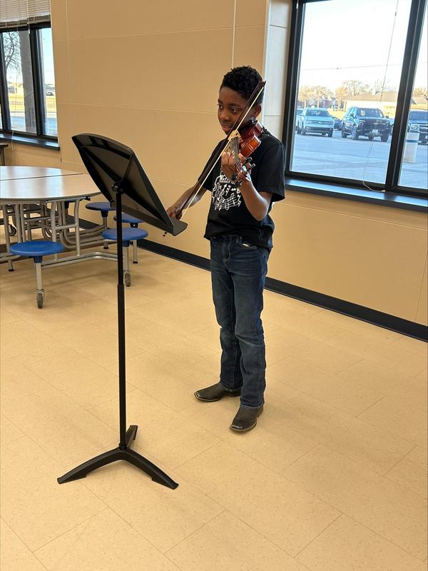 Student practicing their instrument before solo competition