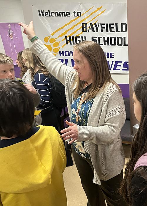 Teacher gesturing during a school event at Bayfield High School.