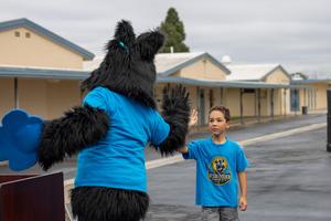 Marshall Mascot greeting a student