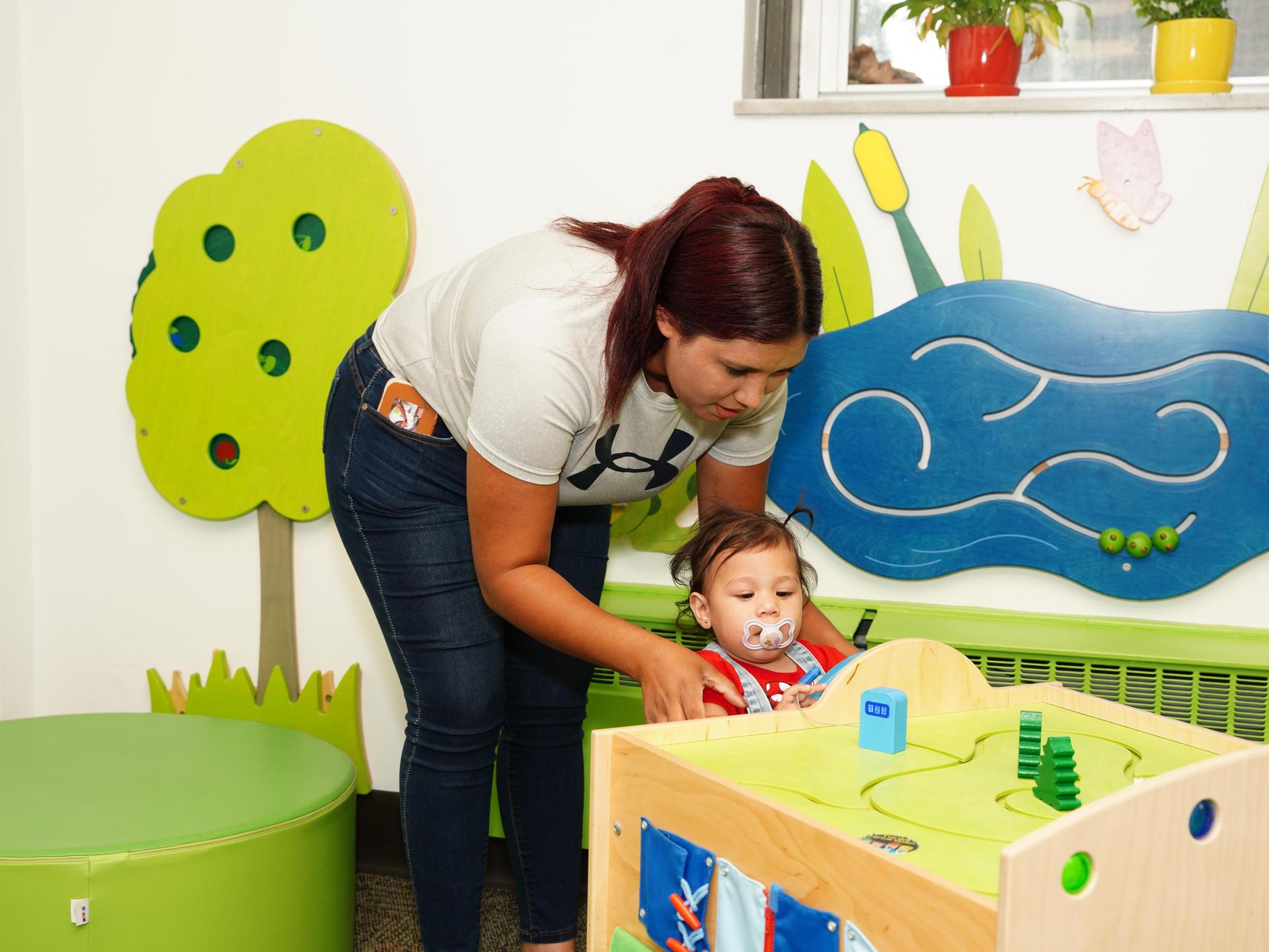 A mom playing with her child in the WIC waiting room.