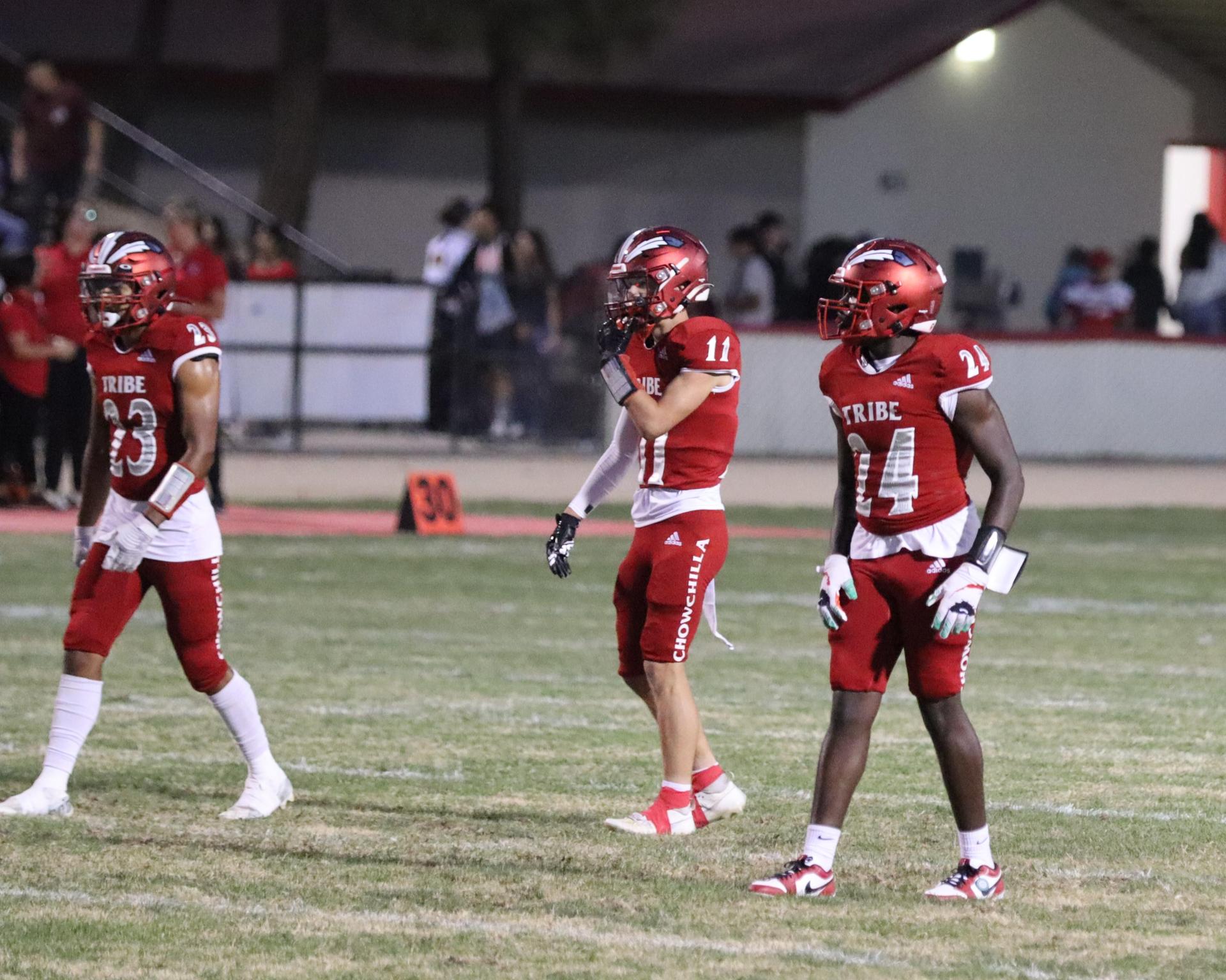 varsity football players in action against Riverdale