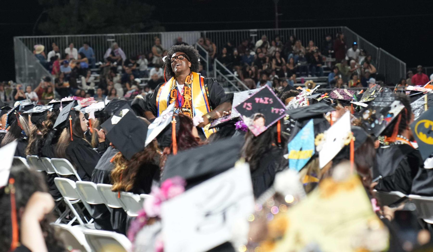 Boy howling with excitement after receiving diploma