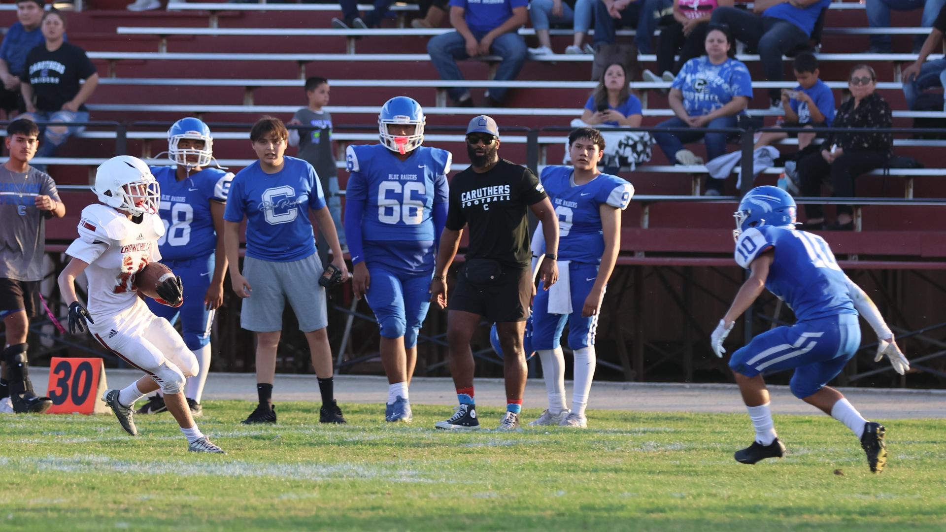 Junior Varsity football players in action against Caruthers