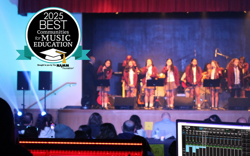 A music performance on stage with students and sound equipment in the foreground.
