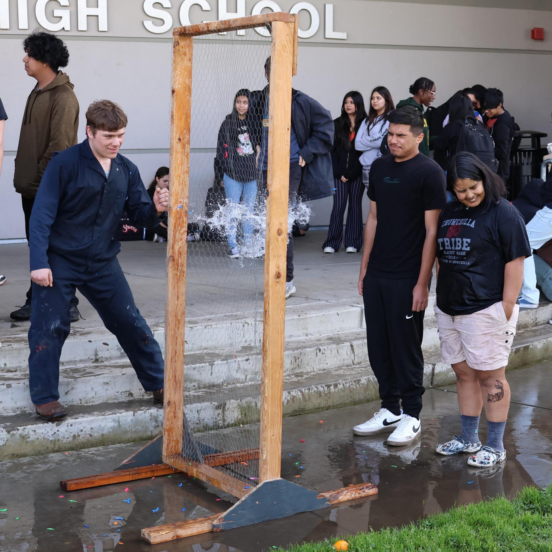 students and staff enjoying the water balloon toss