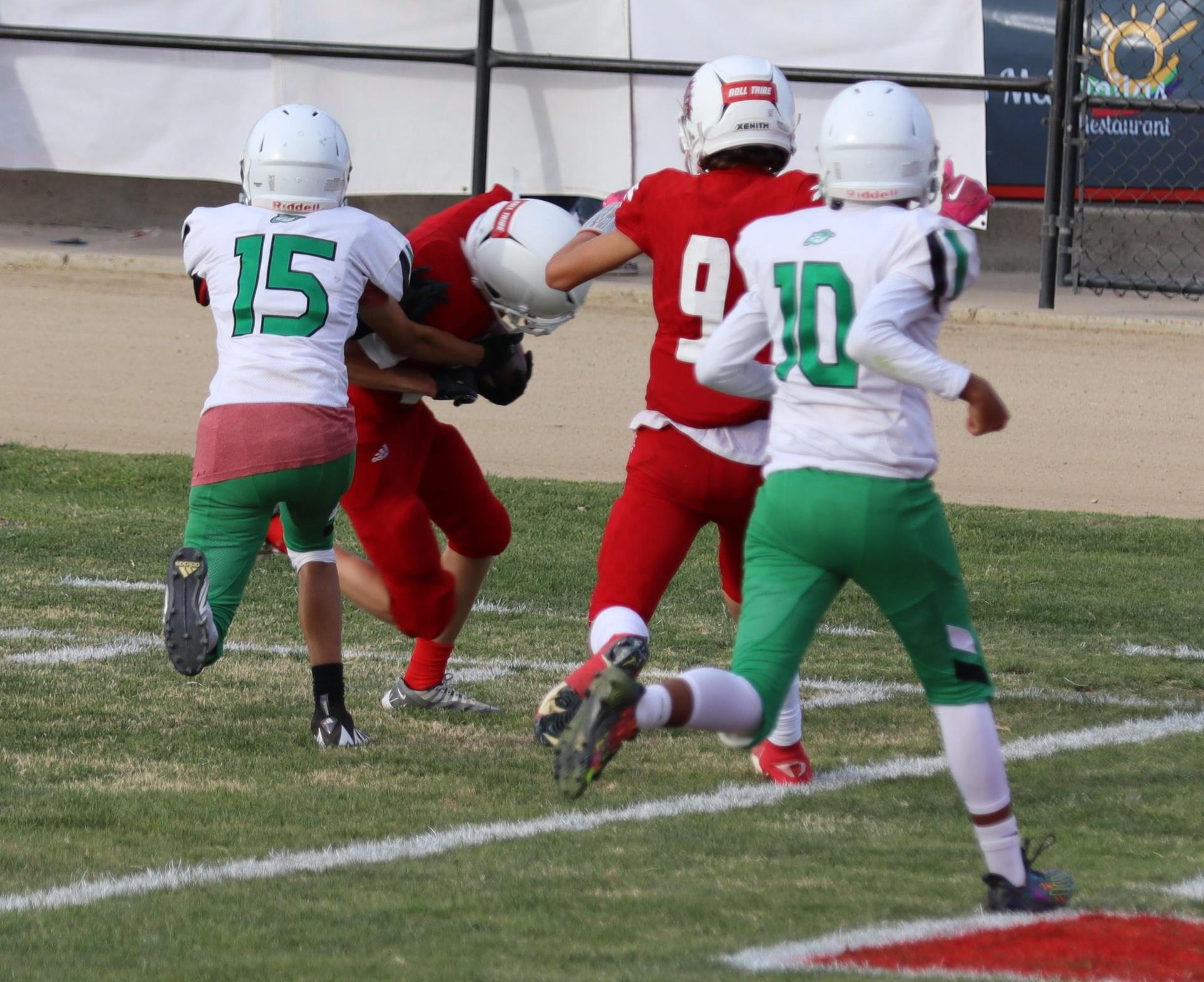  junior varsity football players in action against riverdale