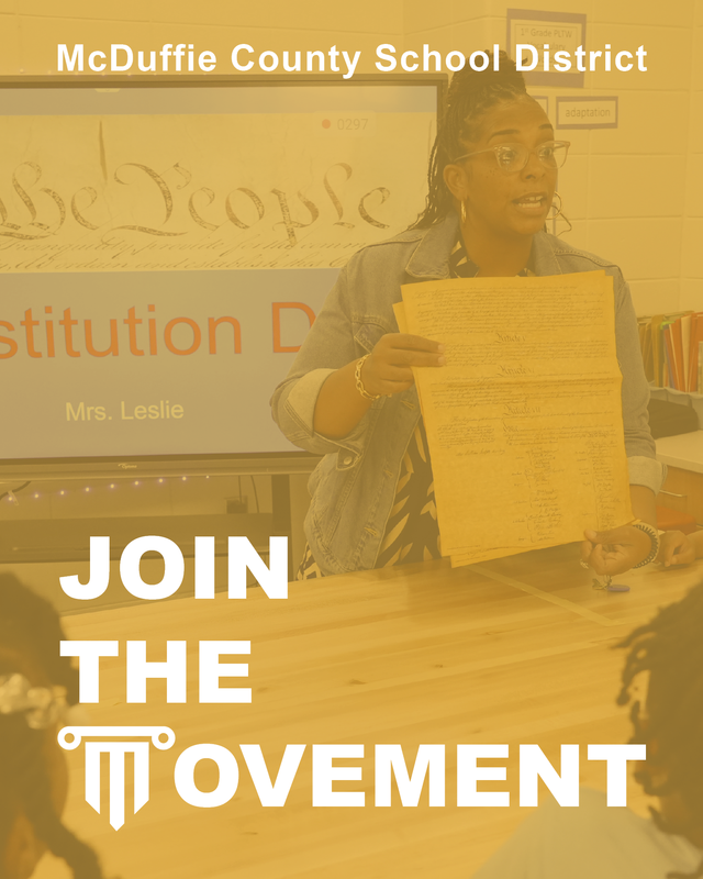 Teacher displaying the U.S. Constitution and the words 