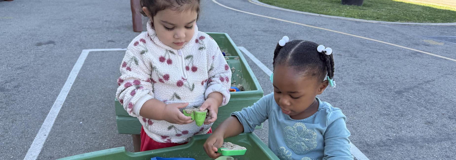 Children playing in sand table