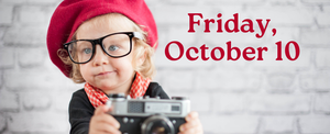 Small female child with red hat and glasses and camera