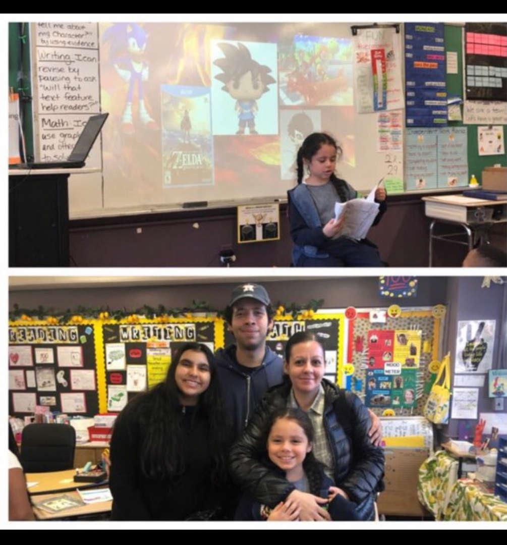 Child reading in front of a presentation, with a family in a colorful classroom.
