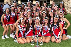 Lorena High School cheerleaders group photo with trophies at UCA Cheer Camp