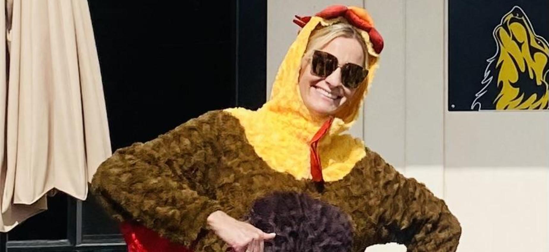 Person wearing a humorous brown turkey costume with red accents.