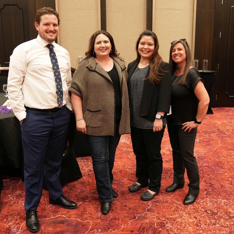Four employees at the Ed Foundation Reception