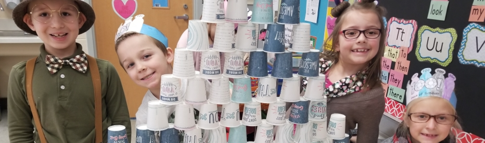Students in Mrs. Weyandt's 1st grade classroom stack 100 cups to celebrate the 100th day of school.