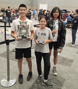 3 kids holding their robots