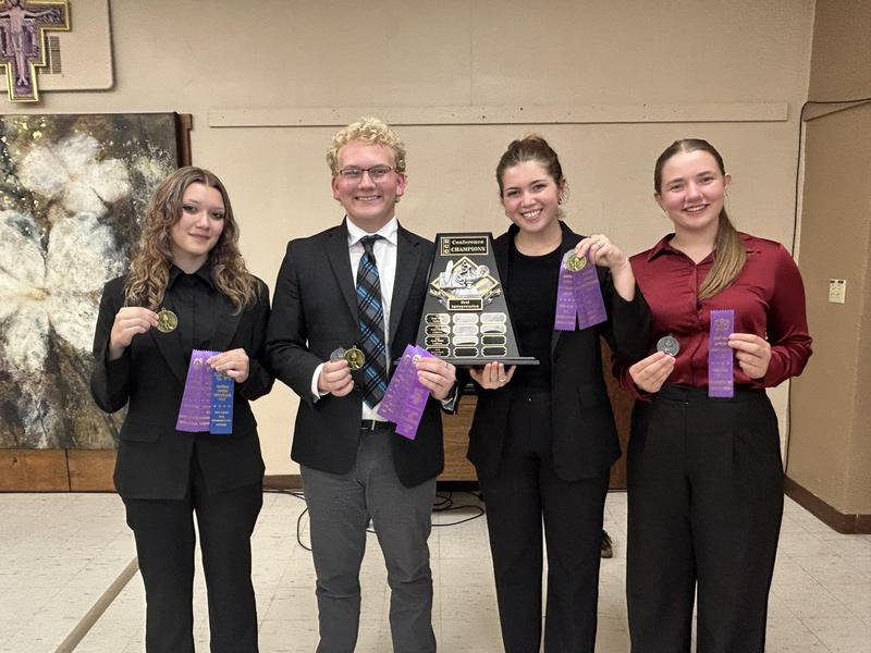 4 oral interpers holding a trophy and medals