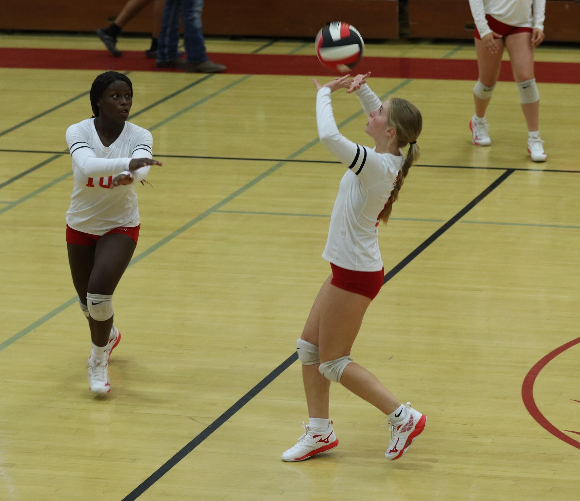 varsity volleyball players in action against liberty