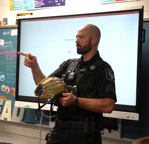 Barry County Sheriff's Sgt. Scott Ware shows students equipment he uses.