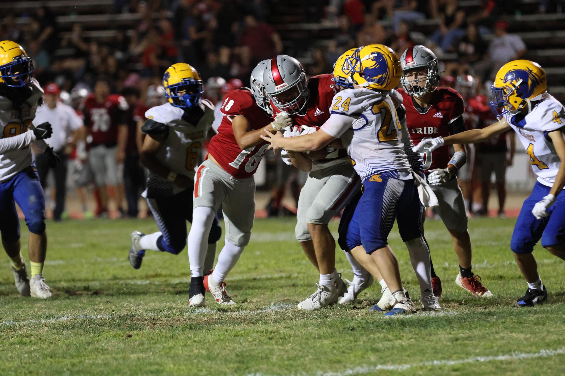 Varsity football players in action against Parlier 113