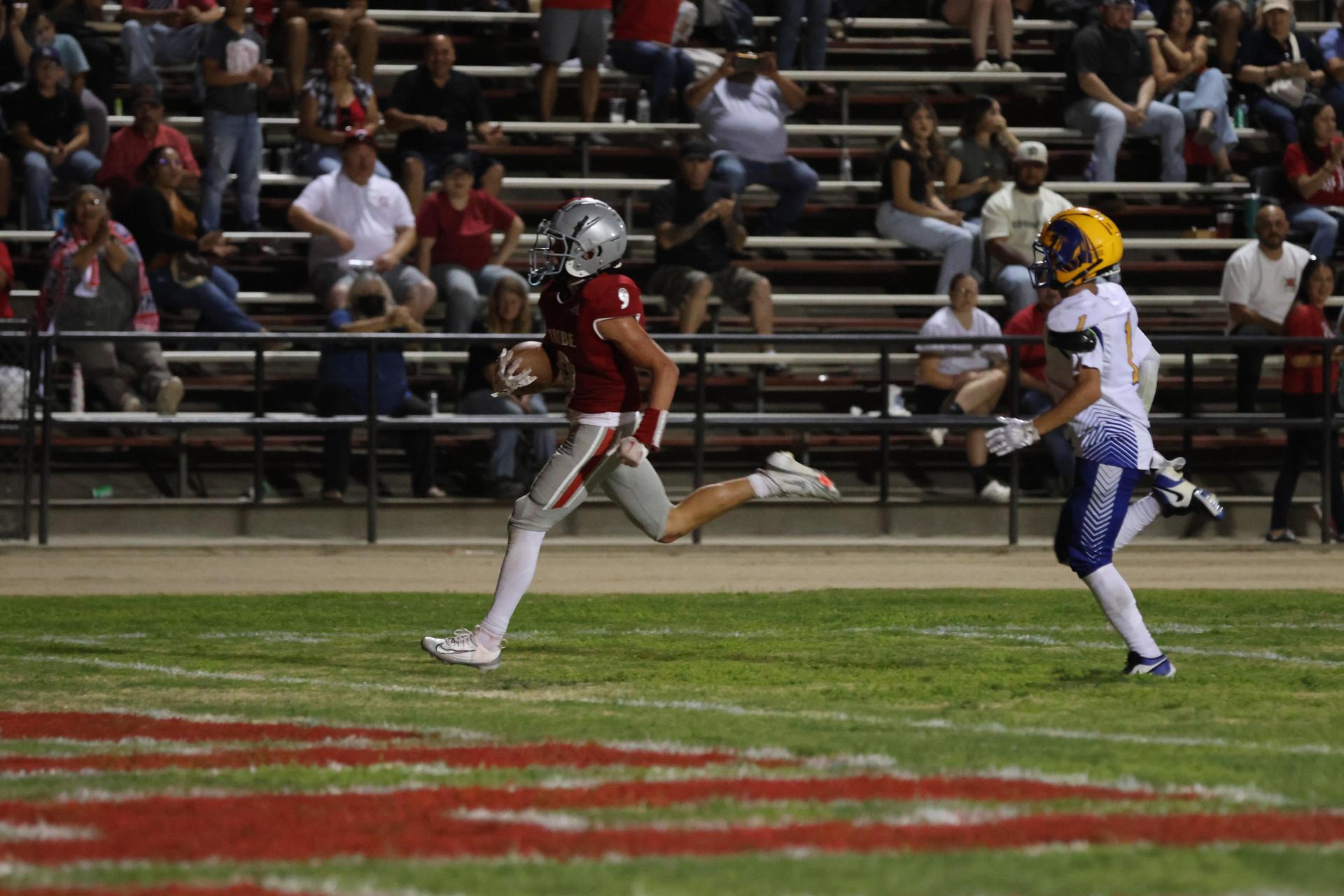 Varsity football players in action against Parlier 28